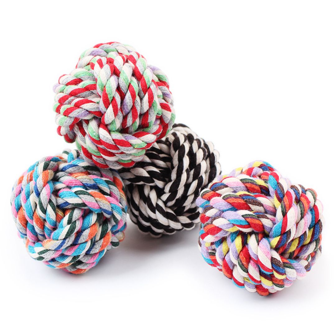 Four colorful rope toys on a white background