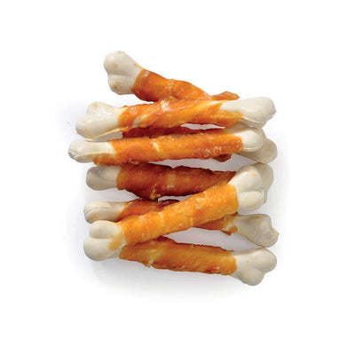 Stack of orange and white bone-shaped treats on a white background