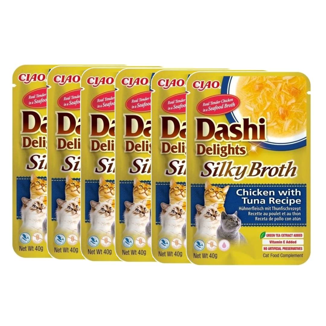 Multiple packages of Dashi Delights Silky Broth cat food on a white background