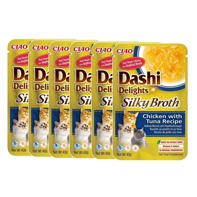 Multiple packages of Dashi Delights Silky Broth cat food on a white background