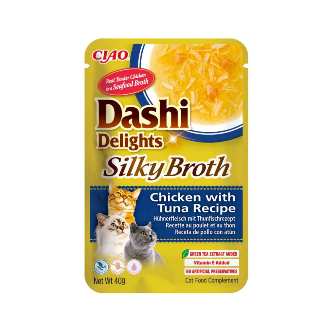 Cat food pouch labeled 'Dashi Delights Silky Broth' with chicken and tuna recipe on a white background.