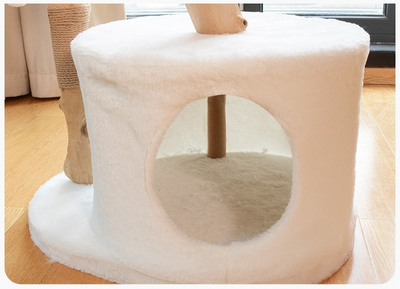 Beige cat tree with a round hole on a wooden floor