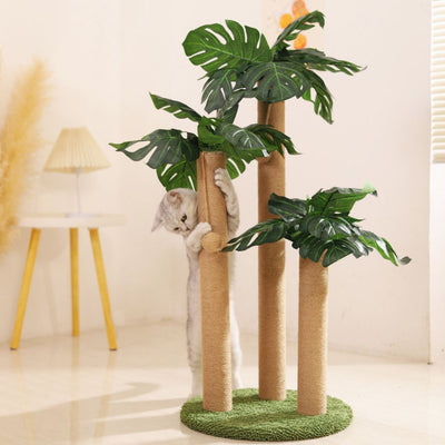 Cat climbing a tree-shaped cat tree with green leaves in a room.