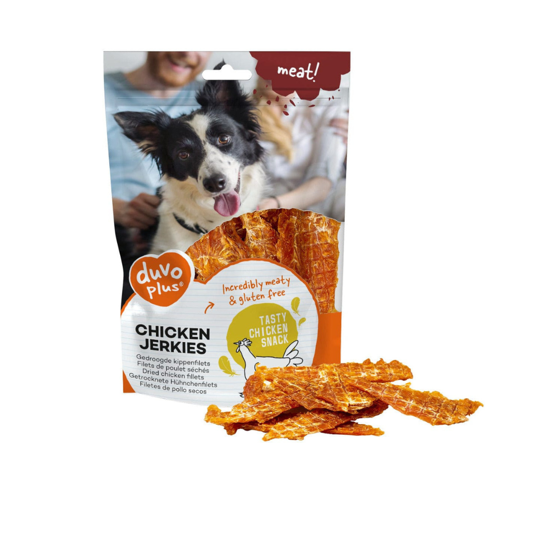 Package of duvo+ Chicken Jerkies for dogs with a dog and family in the background